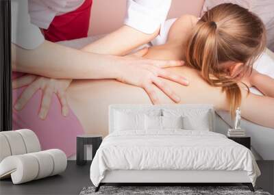 Girl receiving osteopathic treatment of her back Wall mural