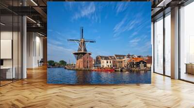 Harlem cityscape - landmark windmill De Adriaan on Spaarne river with boats. Harlem, Netherlands Wall mural