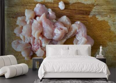 Slices of raw chicken on a wooden board. Wall mural