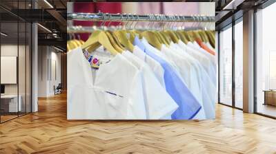 Medical uniform on a hangers in a shop Wall mural