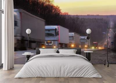 Trucks on a highway in an evening Wall mural