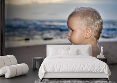 Cute boy sunset portrait on the beach Wall mural