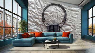 black headphones on a silver background Wall mural