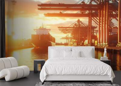 Cargo Ship Docked at Bustling Harbor with Vibrant Sunset Sky, Showcasing Industrial Strength and Commerce Wall mural