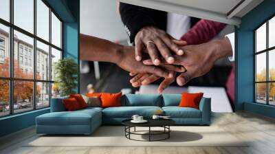 The hands of black people in the center hold each other to unite against racism in large countries. Black lives matter Wall mural