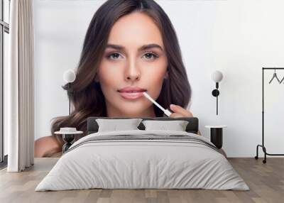 A lip gloss being used on the lips of a beautiful young woman Wall mural