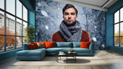 Intense, heavy snowing and a young man wearing a scarf around his neck Wall mural