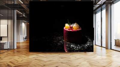 Tasty red cake with fruit on a black background Wall mural