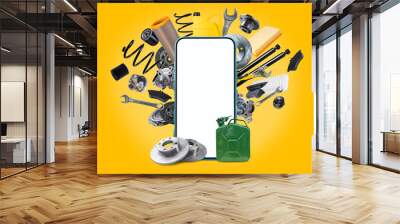 A various of new car spare parts and blank smartphone with white screen for your text or design on yellow background. Template for an application for the sale of spare parts for vehicles. Wall mural