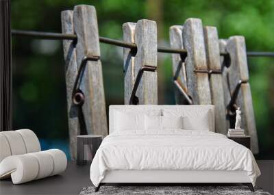 clothespin on the rope. old wooden clothespins on a wire for drying clothes. selective focus and blurred background. Wall mural