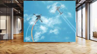 Collision in the air. Two airplane collapse in flight. Aviation accident in blue sky. Damaged engine with fire whirlwind. View from the ground Wall mural