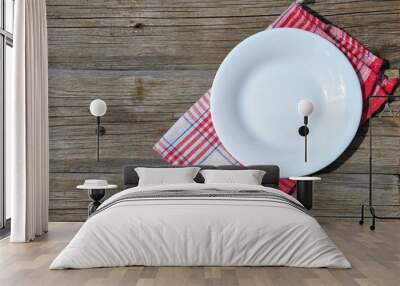 empty white plate on wooden table top view Wall mural