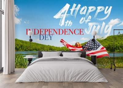 Happy Independence Day, 4th of July. Young woman holding American flag on lake background. Wall mural