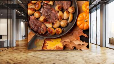 Roast beef steak with roasted potatos in copper pan on wooden table, top view. Wall mural