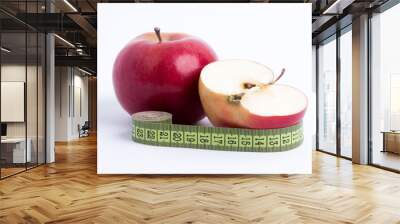 fresh red apple and sliced half with green measuring tape closeup on white background. healthy vegetarian organic food for diet planning, fitness and lose weight Wall mural