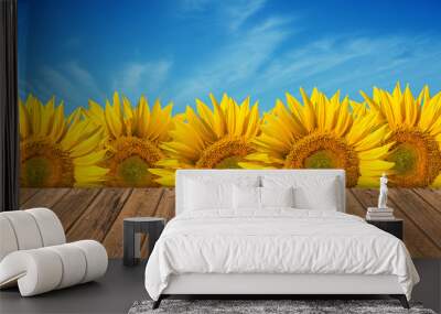 empty wooden table in sunflower field with blue sky. the backgro Wall mural