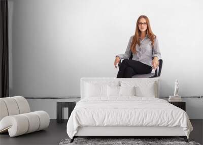 Portrait of beautiful business woman sitting on chair against wh Wall mural