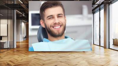 Portrait of happy patient in dental chair. Wall mural