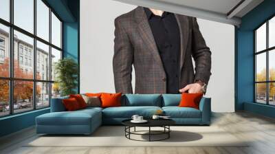 Studio portrait of handsome elegant young man in brown jacket po Wall mural