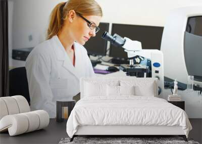 Woman in a laboratory working with samples. Wall mural