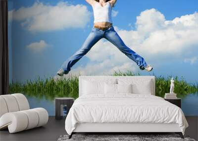 happy young woman is jumping Wall mural