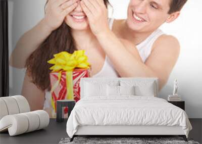 Young man presents gift to woman, on white background Wall mural