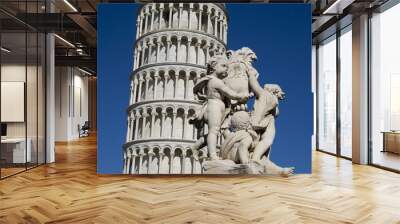 Leaning Tower of Pisa with a statue in foreground Wall mural