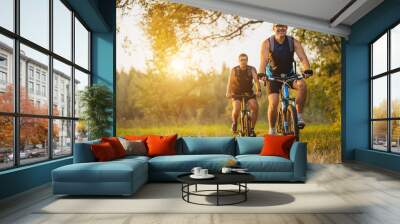 Two mountain bikers riding bike in the forest Wall mural