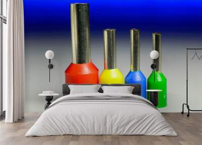 Four colorful ferrules standing in a row on a white background with a blue backlight - macro photo. Wall mural