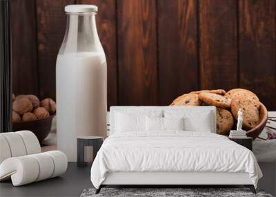 Chocolate chip cookies with milk on burlap and rustic wooden table Wall mural