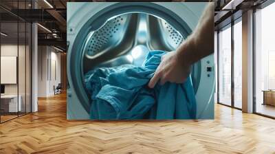 Person placing clothes into a washing machine, realistic colors, detailed shot, modern and professional service concept Wall mural