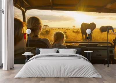 Family on a safari tour watching elephants at sunset in the African savannah, enjoying wildlife and scenic beauty. Wall mural