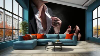 Perfume with man in studio on black background Wall mural