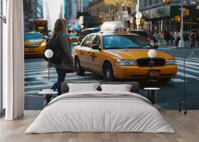 A pedestrian crossing the street next to a taxi Wall mural