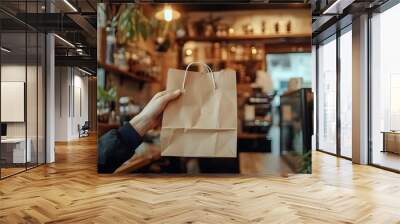 Hand Holding Brown Paper Bag Cozy Cafe Environment Warm Lighting Wall mural