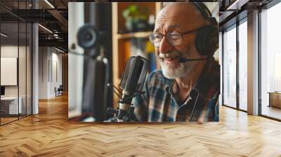 old man giving an interview in a studio with headphones on and a microphone recording Wall mural