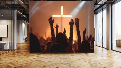 People raising hands in front of a huge cross during sunset Wall mural