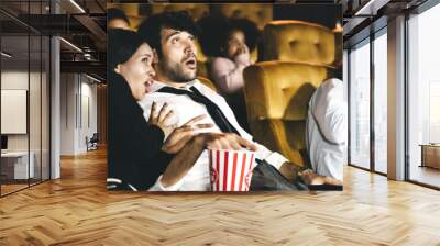 Caucasian men with diversity couple watching cinema in theater Wall mural