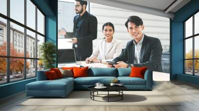 Focus on man entrepreneur. Southeast asian Business people group coworker working in office concept. Happy men sitting and eye looking at camera in boardroom. Wall mural