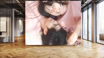 Happy young adult asian lover couple living together in bedroom at home. Wall mural