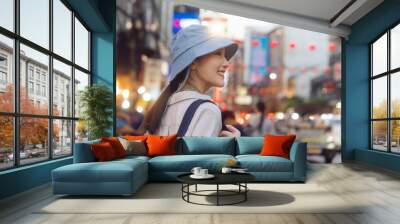 Young adult asian woman traveller backpack traveling in city lifestyle chinatown street food  with bokeh background. Wall mural