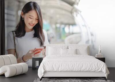 Young adult asian woman using creadit card and smartphone for online shopping and digital wallet Wall mural