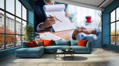 Businesswoman reviewed mortgage document and contract with their client, ensuring loan and credit details were clear, while discussing estate insurance and other finance aspects. finance, credit, pay. Wall mural