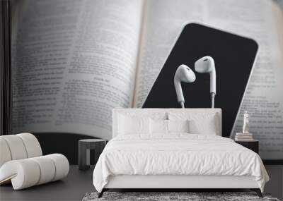 Christian online technology concept. Earphones over the holy bible with digital smartphone, Online live church for sunday service. Holy bible book and online study. Wall mural