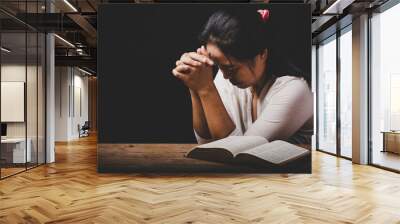 christian woman hand on holy bible are pray and worship for thank god in church with black background, concept for faith, spirituality and religion Wall mural