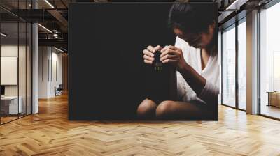 christian woman hand on holy bible are pray and worship for thank god in church with black background, concept for faith, spirituality and religion Wall mural