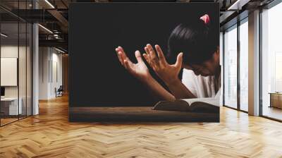 christian woman hand on holy bible are pray and worship for thank god in church with black background, concept for faith, spirituality and religion Wall mural