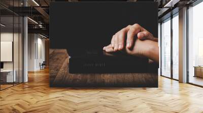 Close up of christian woman hand on holy bible are pray and worship for thank god in church with black background, concept for faith, spirituality and religion Wall mural