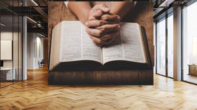 Close up of christian woman hand on holy bible are pray and worship for thank god in church with black background, concept for faith, spirituality and religion Wall mural