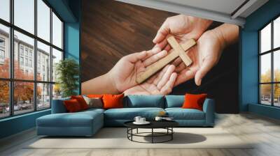 Cross in hand prayer to god on dark in church concept for faith spirituality and religion woman person praying on holy bible in morning. Christian catholic woman hand with worship in black background. Wall mural